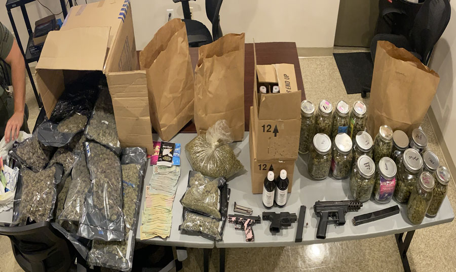 The narcotics investigation resulted in three semi-automatic loaded firearms with ammunition being seized, 21.4 pounds of cannabis packaged for sale and 24 full bottles of promethazine syrup. This syrup is a schedule five controlled substance also known as Lean, Mudd or Sizzurp, $9,960 in illicit money being confiscated.