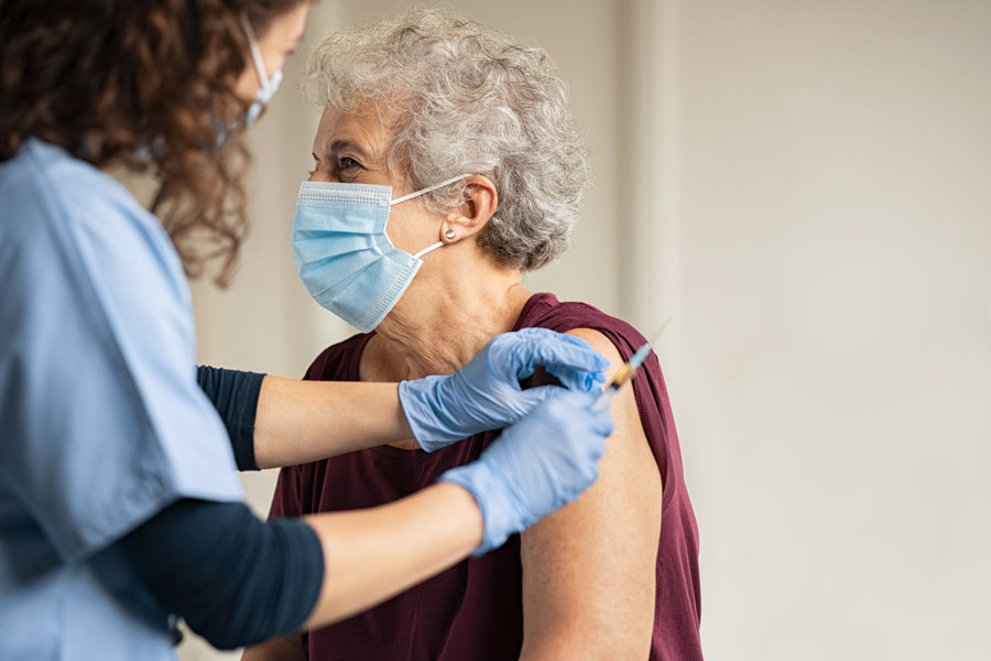 A senior receives a Pfizer-BioNtech Covid-19 vaccine from a healthcare worker at Coral Gables in Miami, Florida. 