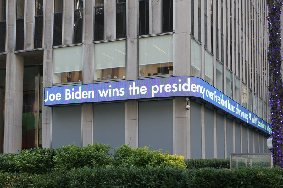 The Fox News ticker outside the News Corp buil ding announces its projection that Joe Biden has defeated Donald Trump in the 2020 presidential election. New York City, New York - November 7, 2020. 