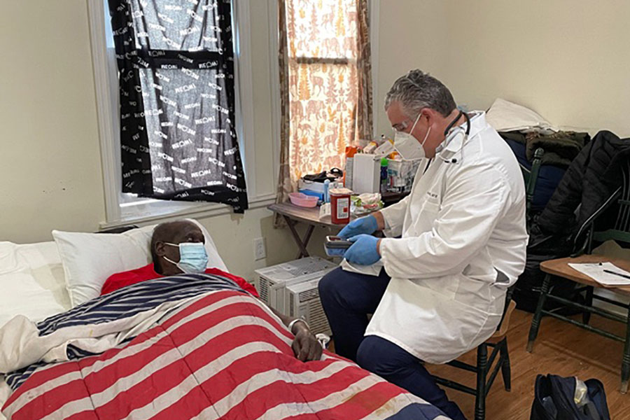 Dr. Steven Landers, president and CEO of the Visiting Nurse Association Health Group, administers the covid-19 vaccine to Sam Ferguson of Asbury Park, New Jersey. Photo credit: Michele Scialabba.