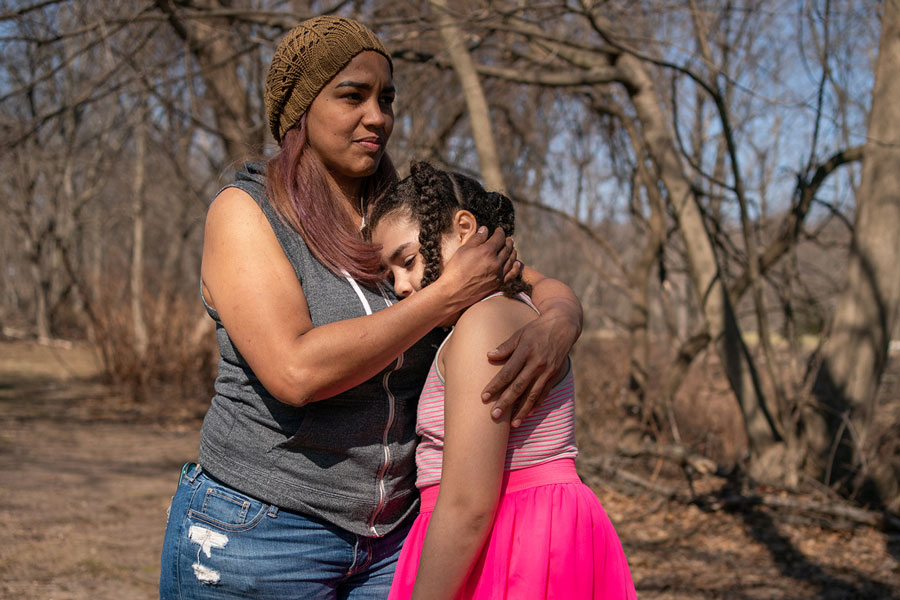 Alexandra Sierra and one of her daughters hug outside their home in Bergen County, New Jersey, on March 9. 