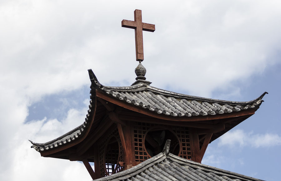 A Christian cross on top of a Chinese Christian church. 