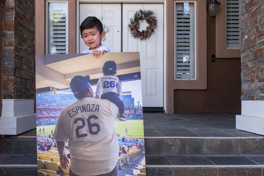 Ezekiel Espinoza holds a photograph of his first Los Angeles Dodgers game with his dad, Antonio.