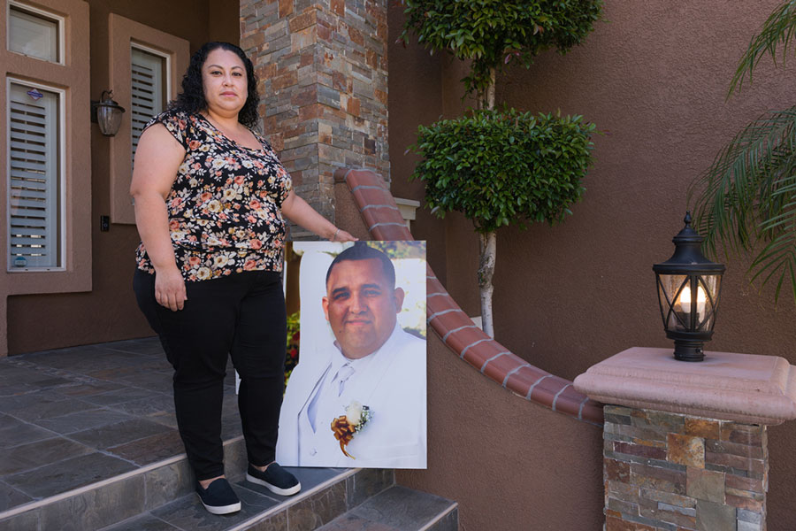 Nancy Espinoza holds a photograph of her husband, Antonio, that had been displayed at his memorial service in March. He died of covid-related complications on Jan. 25, 2021. 