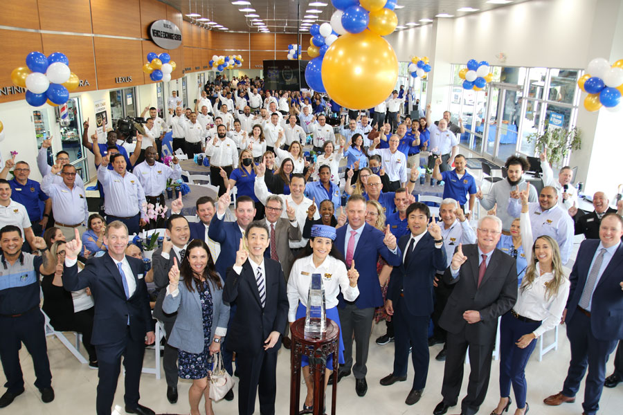 Rita Case, President & CEO of Rick Case Automotive Group and Noriya Kaihara, President & CEO of American Honda Motor Company with the Rick Case Honda team celebrating being #1 at Honda. 