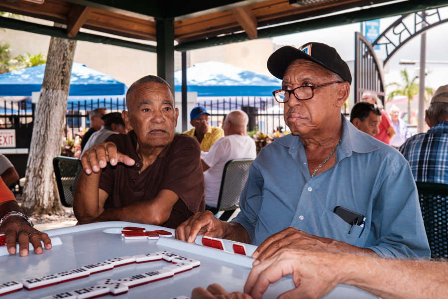 Unidentified senior men playing the domino game in the historic Domino Park in popular Little Havana.