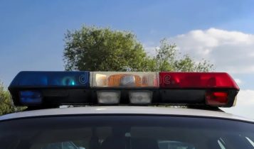 @JohnDoeNeighbor – Taken at 8:45 PM outside driveway, flashing police lights visible
